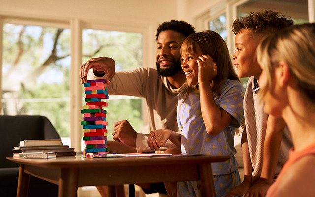 Family playing tabletop game in living room